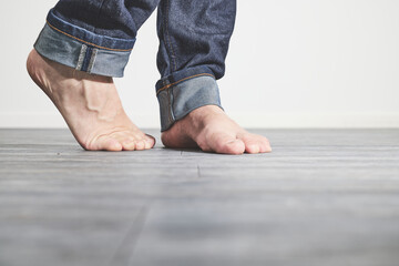 Male feet barefoot on floor