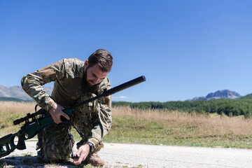 Special operations soldiers team preparing tactical and communication gear for action battle. Long distance sniper team in checking gear for action