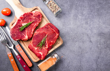 Wall Mural - Fresh beef steak on a concrete background