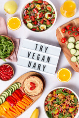 Wall Mural - Vegan or veganuary feast with various salads ad healthy plates on light gray table