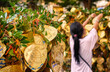 Buddhist golden leaves with wishes on Bodhi tree, female adult in