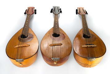 Wall Mural - Three old mandolins isolated on a white background. Selective focus.