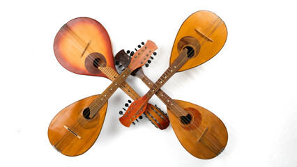 Wall Mural - Four crossed vintage mandolins. Isolated on white background. Panoramic photo.