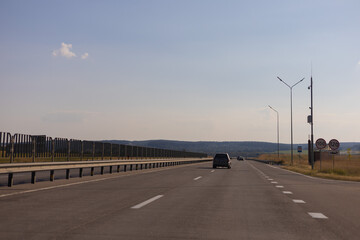 Evening view at sunset. Highway road in the countryside, roadside and asphalt