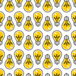 Seamless pattern with densely spaced hand drawn yellow light bulbs.