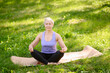 © GRON777 - Athletic middle-aged woman doing yoga outdoors in a city park.Meditation concept
