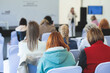 © tsuguliev - Audience at the conference hall listens to lecturer, people on a congress together listen to speaker on a stage at master-class, corporate business seminar