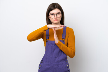 Wall Mural - Young Russian woman isolated on blue background making time out gesture