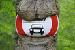 © Designpics - Traffic Sign on an Overgrown Tree, Hesse, Germany