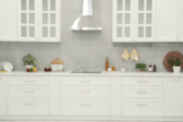 Poster - White cosy kitchen with furniture, blurred view. Interior design