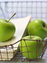 Green Apples And Envelopes In Wire Tray