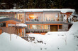 © Designpics - Exterior View of People inside Alpine Home in Winter, Whistler, British Columbia, Canada