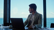 © stockbusters - Young businessman looking panorama window. Concerned boss relaxing after work