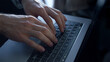 © stockbusters - Closeup director hands work laptop at dark office. Unknown man typing keyboard