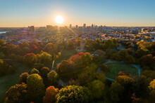 Aerial Drone View Of Patterson Park In Baltimore City In Fall At Sunset With The City Skyline In The Distance