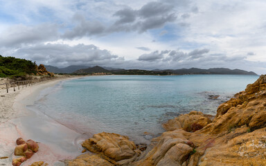 Wall Mural - landscape view Porto Giunco Beach near Villasimius in Sardinia with red granite boulders in the foreground