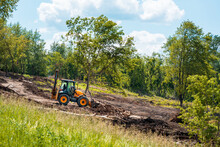 Tractor Works On Landscaping, Tree Branches And Debris