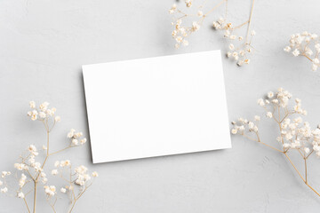 Wall Mural - Blank minimalistic card mockup with botanical decoration, top view with copy space