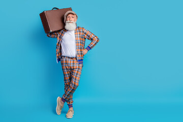 Sticker - Full length photo of serious confident man hold valise preparing flight abroad nice vacation empty space isolated on blue color background