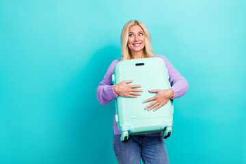 Poster - Photo of positive nice person hands hold suitcase look empty space isolated on teal color background