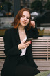 © teksomolika - Young woman uses the phone at the street cafe