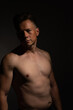 © Collins Photography - Sexy portrait of muscular handsome topless male isolated against a black background
