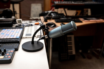 Professional microphone on a working table in a recording studio