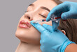 © Dimid - Cosmetologist does injections for lips augmentation anti wrinkle injections on the face of a beautiful woman. Female aesthetic cosmetology in a beauty salon.