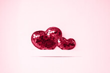 Two Red Hearts On A Pink Background With Copy Space. Valentine's Day Concept. Viva Magenta Color.
