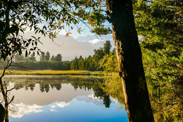 Poster - Reflections in Lake Mathieson surrounded by natural bush and forest and Southern Alps mountain range