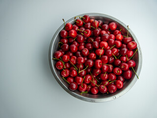 red cherry lay in iron vessel background, cherry tails