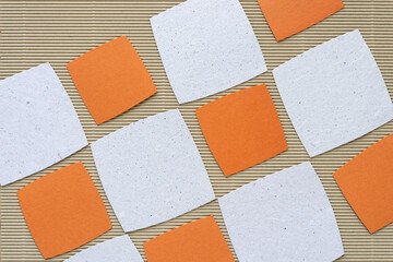 Wall Mural - orange and stone white, textured rounded paper square shapes on beige corrugated paper