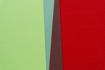 Poster - smooth green and brown paper (with triangle elements) and red corrugated paper