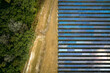 © bilanol - Aerial view of big sustainable electric power plant with many rows of solar photovoltaic panels for producing clean electrical energy. Renewable electricity with zero emission concept