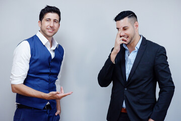 Handsome young businessman in suit smiling on white background successful business ideas.