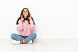 © luismolinero - Young caucasian woman sitting on the floor isolated on white background smiling with a happy and pleasant expression