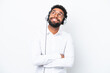 © luismolinero - Telemarketer Brazilian man working with a headset isolated on white background looking up while smiling