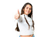 Young girl over isolated chroma key background with thumbs up because something good has happened