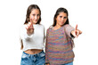 © luismolinero - Friends girls over isolated chroma key background showing and lifting a finger