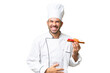 Young caucasian chef holding a sushi over isolated background smiling a lot