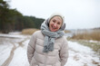 © Евгений Шемякин - Portrait of happy beautiful elderly senior retired woman in age is playing, having fun with snow outdoors in forest or park at winter cold day, smiling, enjoy weather