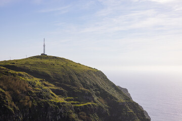 Wall Mural - Amazing lighthouse on a high cliff on the Madeira coast in Portugal.