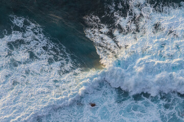 Wall Mural - Great waves in the Atlantic Ocean that are illuminated by the sun and therefore shine so beautifully.