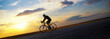 © Solid photos - Young sports man cycling with bicycle on the road in summer