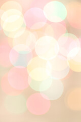 Blurred colored lights on light pink background