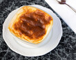 © ozgur - Baked rice pudding Turkish milky dessert sutlac in an earthenware casserole.