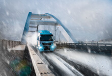 Modern Fast White Semi Truck On Snowy Day On The Bridge Carrying Load 