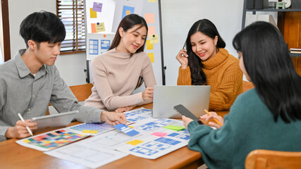 Canvas Print - a group of smart business startup team are in the meeting to discuss and plan their new mobile app