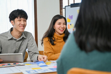Canvas Print - happy asian business team startup in the meeting with developer and graphic designer