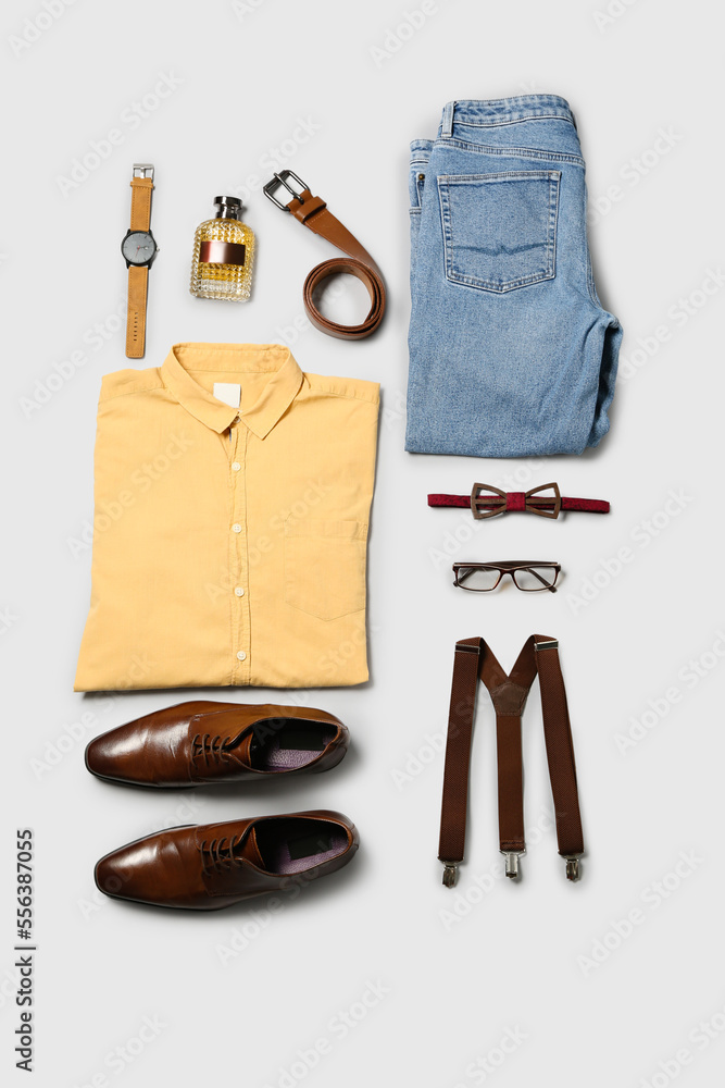 Male clothes and accessories on light background